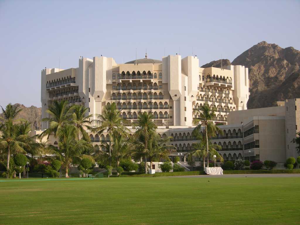 Muscat 05 Al Bustan 03 Outside View Of Hotel Opened in 1985, the Al Bustan Palace InterContinental Muscat hotel has built a reputation as one of the best hotels in the Middle East and one of the finest hotels in the world. Situated eight kilometres from the downtown business district, the hotel is nestled on the coast surrounded by a dramatic mountain backdrop, sea and beach, and set in 200 acres of lush, green gardens. It enjoys spectacular views over the Gulf of Oman.